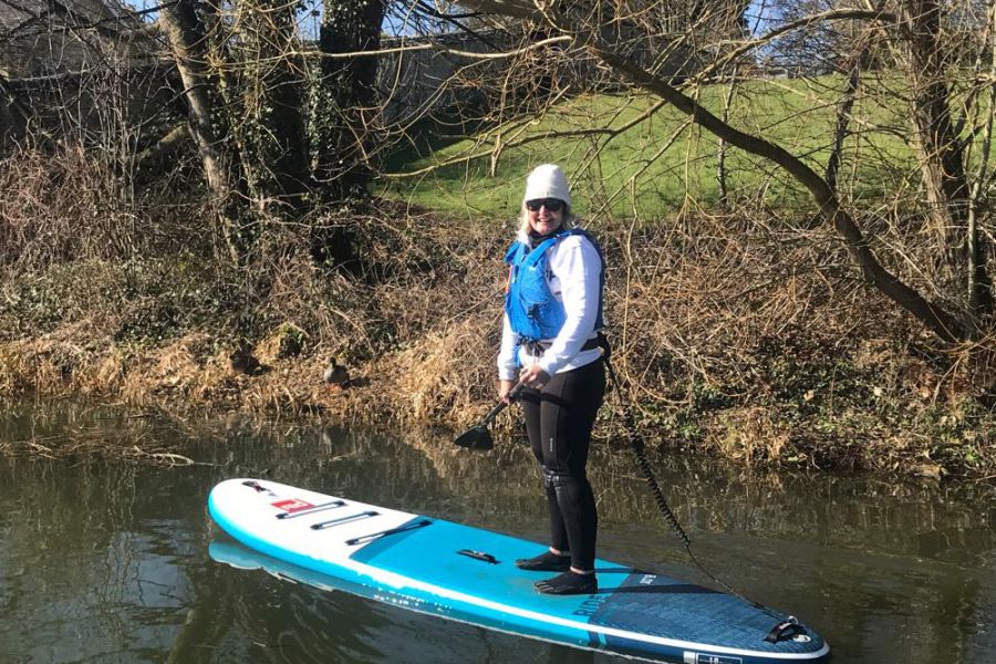 Moira doing paddleboarding in the winter